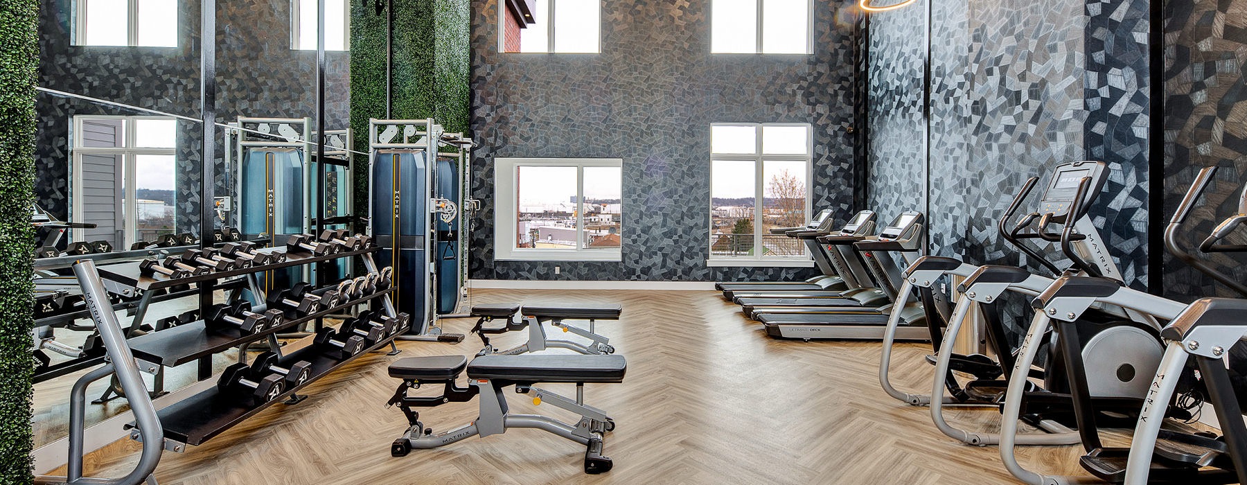 State-of-the-Art Fitness Center with high ceilings and large windows